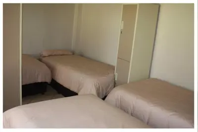 a room with two beds and a closet with mirrors at Cosy farmhouse for 4 persons in Lephalale