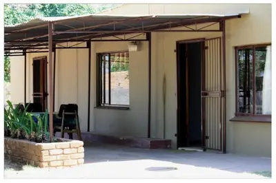 a porch of a house with an open door at Cosy farmhouse for 4 persons in Lephalale