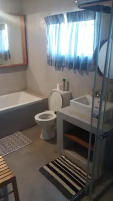 a bathroom with a toilet and a tub and a sink at 3 Single bedroom in farmhouse in Limpopo Province in Lephalale