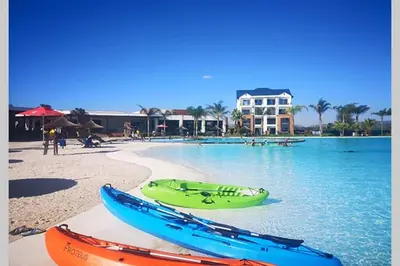 two canoes sitting on a beach next to the water at The Blyde - Little Place, Lots of Relaxation in Pretoria