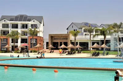 a large swimming pool in a resort with buildings at The Blyde - Little Place, Lots of Relaxation in Pretoria