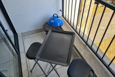 a table and two chairs on a balcony at The Blyde - Little Place, Lots of Relaxation in Pretoria