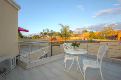a balcony with a table and two chairs and a view at Royal Hills Lodge and Spa in Thohoyandou