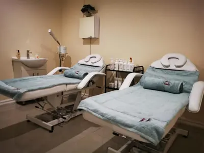 a hospital room with two beds and a sink at Royal Hills Lodge and Spa in Thohoyandou