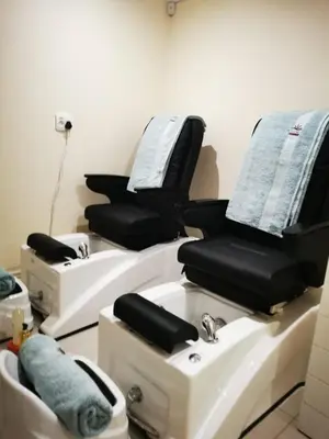 a room with three salon chairs and a sink at Royal Hills Lodge and Spa in Thohoyandou