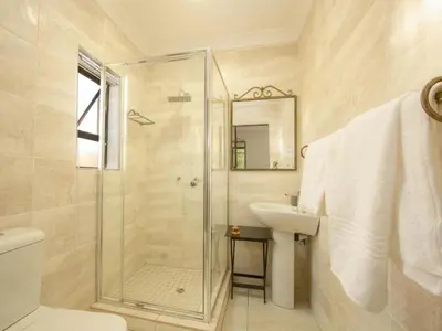 a bathroom with a shower and a sink at Royal Hills Lodge and Spa in Thohoyandou