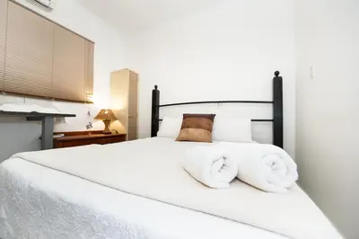 a bedroom with a white bed with towels on it at Interlude Guest House in Thabazimbi