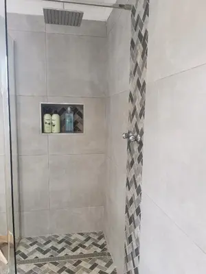 a bathroom with a shower with a glass door at SiriMiri Cottage Dullstroom in Dullstroom
