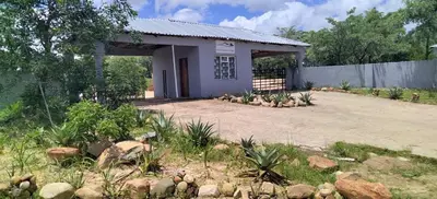 a house with a lot of rocks in front of it at Moholoholo Lodge in Acornhoek