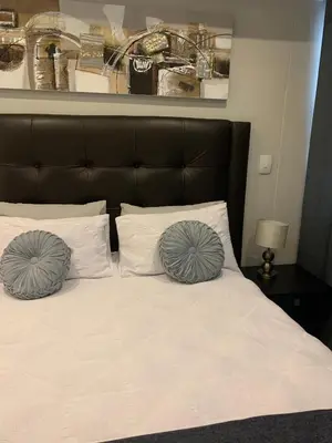 a bedroom with a bed with two pillows on it at Regency Hotel Apartment @ 4th in Pretoria