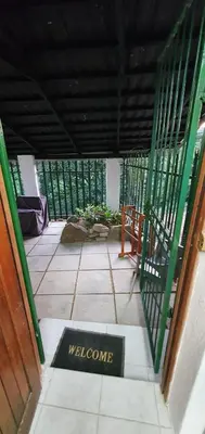 a welcome sign on the floor of a porch at Sister's Haven in Nelspruit