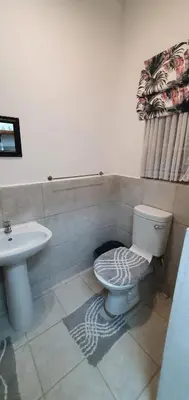 a bathroom with a toilet and a sink at Sister's Haven in Nelspruit
