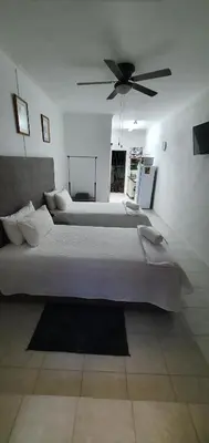 a bedroom with two beds and a ceiling fan at Sister's Haven in Nelspruit