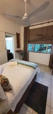 a large bed in a room with a large window at Sister's Haven in Nelspruit