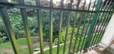 a fence with a view of a garden at Sister's Haven in Nelspruit