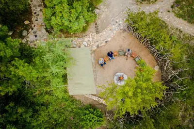 a group of people sitting in a circle in a yard at Bundox Explorer Camp in Hoedspruit