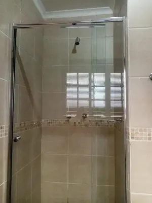 a shower with a glass door in a bathroom at Tumi's Home away- 3 Bedroom in Witbank