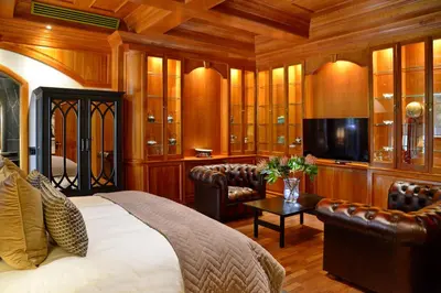 a bedroom with a bed and a flat screen tv at Apogee Boutique Hotel & Spa in Pretoria