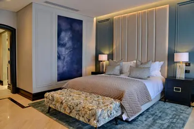 a bedroom with a large bed and a couch at Apogee Boutique Hotel & Spa in Pretoria