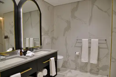 a bathroom with a sink and a toilet and a mirror at Apogee Boutique Hotel & Spa in Pretoria
