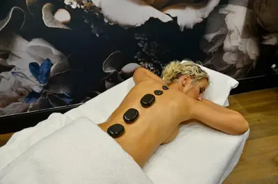 a woman laying on a bed with a shirtless at Apogee Boutique Hotel & Spa in Pretoria