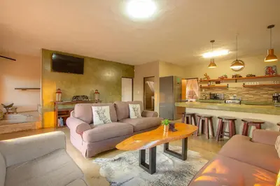 a living room with a couch and a table at Doornkom in Marloth Park