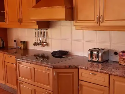 a kitchen with wooden cabinets and a sink and a toaster at Amberley Mountain Reserve in Dullstroom
