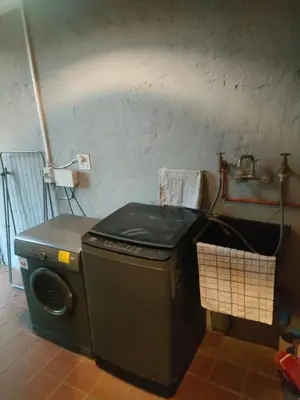 a washing machine in a room with a sink at Karee Laagte in Leeuwfontein