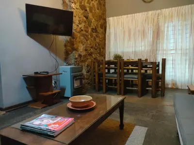 a living room with a table and a television at Karee Laagte in Leeuwfontein