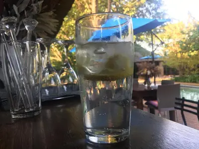a glass of water sitting on top of a table at Midrand Wild Goose Guest House B&B in Midrand