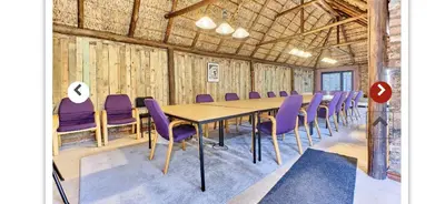 a conference room with a table and purple chairs at Midrand Wild Goose Guest House B&B in Midrand