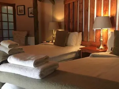 a hotel room with two beds with towels on them at Midrand Wild Goose Guest House B&B in Midrand