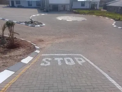 a stop sign on a brick parking lot at SIMA SILVER LODGE in Tzaneen