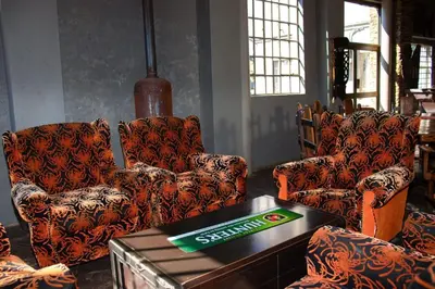 a living room with two chairs and a table at SIMA SILVER LODGE in Tzaneen