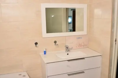 a bathroom with a sink and a mirror at RAMATA GUEST HOUSE in Pretoria