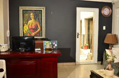 a room with a painting of a woman on a wall at RAMATA GUEST HOUSE in Pretoria