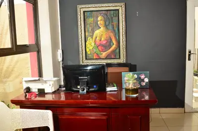 a desk with a picture of a woman on the wall at RAMATA GUEST HOUSE in Pretoria