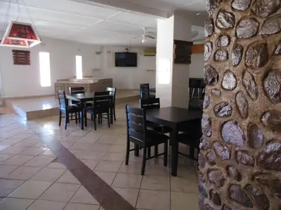 a dining room with a table and chairs at El Rancho Grande in Warmbaths