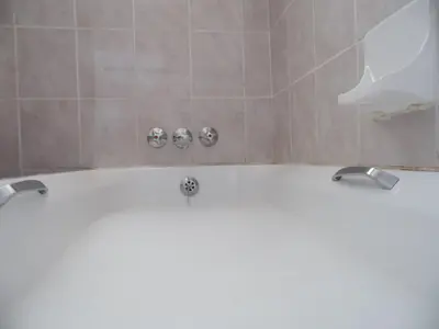 a bath tub with two faucets in a bathroom at El Rancho Grande in Warmbaths
