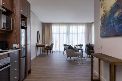a living room with chairs and a dining room at Radisson Hotel and Convention Centre OR Tambo Airport in Johannesburg