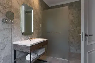 a bathroom with a sink and a mirror at Radisson Hotel and Convention Centre OR Tambo Airport in Johannesburg