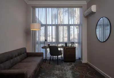 a living room with a couch and a table and a window at Radisson Hotel and Convention Centre OR Tambo Airport in Johannesburg