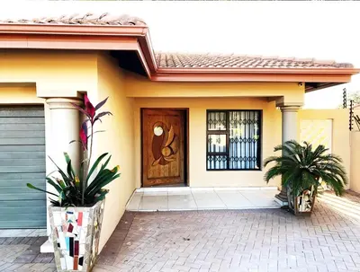 a house with a wooden door and a porch at Hush Guest House in Northam