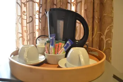 a tea pot and cups in a wooden tray at Hush Guest House in Northam