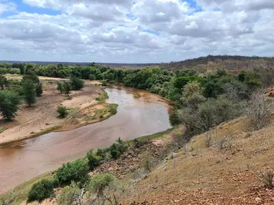an aerial view of a river in a field at Nthakeni Bush & River Camp in Pafuri Gate