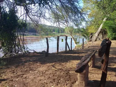 a bench sitting next to a body of water at Nthakeni Bush & River Camp in Pafuri Gate