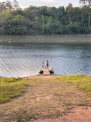 two people standing on a dock in a lake at DaGama Dam - White River - Kestrel - House 21 in White River