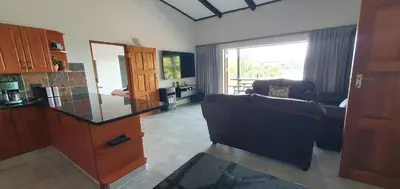 a living room with a couch and a glass counter at DaGama Dam - White River - Kestrel - House 21 in White River