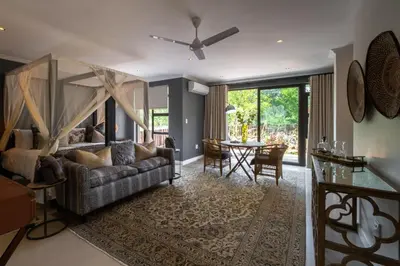 a living room with a couch and a table at Safari Moon Luxury Bush Lodge in Hoedspruit