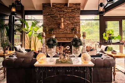 a living room with a couch and a table at Safari Moon Luxury Bush Lodge in Hoedspruit